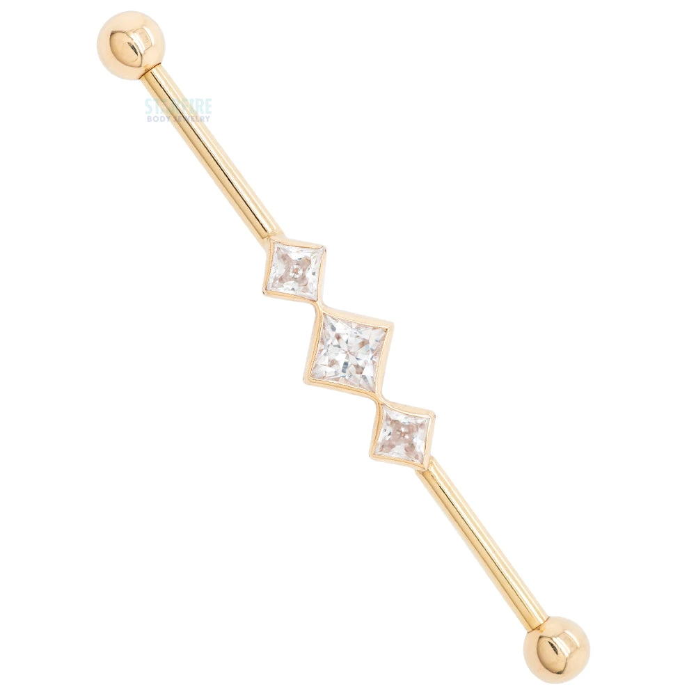 "Jenna" Industrial Barbell In Gold With In-Line Princess-Cut White CZ's 3 "Jenna" Industrial Barbell In Gold With In-Line Princess-Cut White CZ's