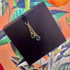 "Junto" Chain Charm In Gold With Gemstones -Starfire – Body Jewelry 41662 Hialeah Fine Jewelry Junto Chain Charm in Gold with Gemstones Single Peridot Swiss Blue Topaz VENDOR PHOTO